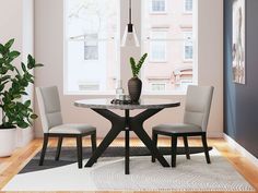 a dining room table with two chairs and a potted plant in the corner next to it