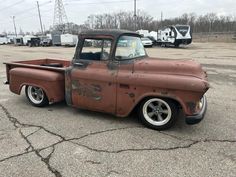 an old truck parked in a parking lot