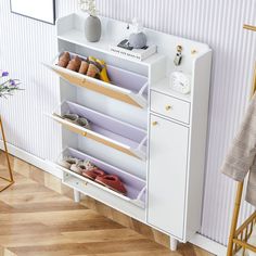 a white cabinet with shoes on it in a room