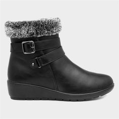 a woman's black ankle high boots with fur linings and buckles on the side