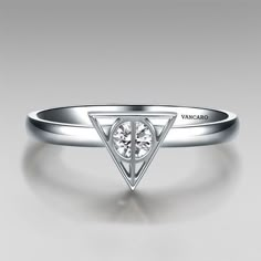 a white gold ring with a triangle shaped diamond on the top and bottom, set in 18k white gold