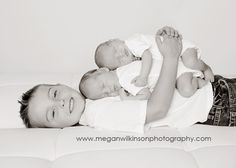 two young boys laying on top of each other