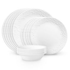 white dinnerware set with ornate design on the front and side, all in different sizes