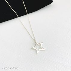 "Gorgeous shiny sterling silver open star necklace. This lovely simple star charm is available on a choice of sterling silver chains and lengths. A stylish necklace perfect for everyday styling, to compliment your look. Select a length to suit your style, and wear solo or layer with other necklaces. Lovely necklace you'll love to wear or love to give. ☆ Select chain style and length when adding to basket. ☆ P R O D U C T ∙ D E T A I L S  ∙ Metal: 925 Sterling Silver  ∙ Star approximately 20mm  ∙ Necklace comes with two number charms  ∙ Spring clasp fastening  ∙ Hypoallergenic ∙ Nickel and lead free  ∙ Gift-ready in our stylish white KookyTwo box  ∙ Handmade by us in our UK studio ☆ C H A I N ∙ L E N G T H  Length: Measurement from end to end including the clasp.  ∙ Trace Chain:  18\"   ∙ C Minimalist Star-shaped Everyday Jewelry, Simple Star-shaped Jewelry With Star Charm, Minimalist Star Charm Necklace, Silver Star Print Necklace, Everyday Star Charm Necklace, Silver Necklace With Star Print For Gift, Silver Star Print Necklace Perfect For Gift, Silver Star Print Necklace For Gift, Minimalist Star Shaped Jewelry With Star Charm