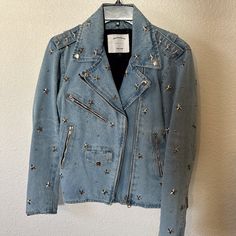 Size M. Light Wash Denim Moto Jacket With Star Studs On Entire Garment. Lightly Worn. Long Sleeves With Zipper Details On Sleeves. Zip Up. Pockets On Front. Spring Denim Biker Jacket, Blue Star Print Outerwear For Fall, Winter Denim Outerwear With Star Print, Denim Outerwear With Star Print For Spring, Fall Denim Jacket With Star Print, Spring Denim Outerwear With Star Print, Trendy Denim Outerwear With Star Print, Trendy Denim Star Print Outerwear, Studded Denim