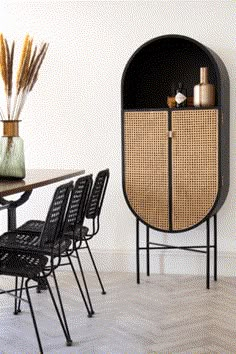 a table with chairs and a cabinet in the corner next to it on top of a hard wood floor