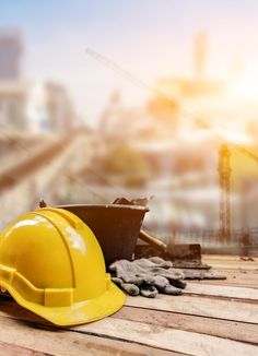 a hard hat and other construction equipment on a wooden floor