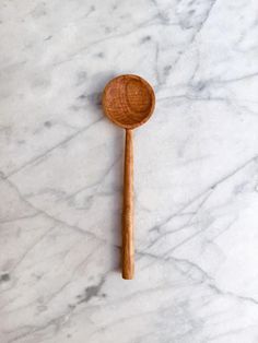 a wooden spoon sitting on top of a marble counter