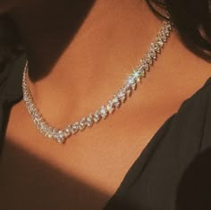 a woman wearing a diamond necklace