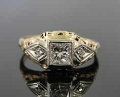 an antique diamond ring on a reflective surface