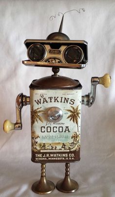 an old fashioned tin can robot holding a beer bottle