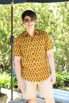 Our Amber Amer Men's shirt is so super soft and such a great colour combination. We have named it after the Amer Fort in Jaipur where this shirt is made. Block printers in Jaipur have practiced this art for centuries. This shirt will be a favourite for the summer! 100% cotton Wash cold, hang dry. Made in India This fabric is block printed by hand so slight variations in printing may exist which demonstrate the hand made aspect of this product. Traditional Fit Short Sleeve Shirt, Traditional Printed Yellow Tops, Festive Short Sleeve Cotton Shirt, Festive Cotton Short Sleeve Shirt, Traditional Cotton Shirt For Festivals, Traditional Printed Shirt For Festivals, Cotton Ikat Print Short Sleeve Top, Traditional Printed Shirt With Relaxed Fit, Traditional Printed Relaxed Fit Shirt