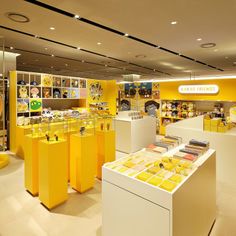 the interior of a store with yellow and white displays