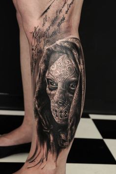 a man's leg with a tattoo on it that has an image of a dog