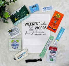 the contents of an emergency survival kit laid out on top of a white blanket with green plants