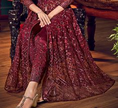 COLOR : Maroon FABRIC : Top - Net, Bottom (Lehenga & Pants) - Satin, Dupatta - ChiffonWORK : Heavy Resham Work, Tonal Sequins, Stones, Lace Border OCCASION : Wedding, Reception, EngagementADDITIONAL INFO : The gown comes with both lehenga and pant style bottom. READY-TO-WEAR : NoSTITCHING : Available as semi-stitched fabric, can be stitched using standard size option (+$30). Note: There might be a slight color variation due to lighting and flash used during photoshoot. The bright shade seen is t Lehenga Pants, Wedding Anarkali, Maroon Fabric, Resham Work, Anarkali Gown, Lace Border, Anarkali, Fashion Pants, Lehenga