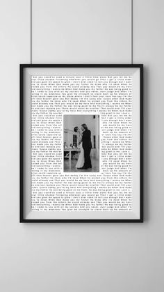 a black and white photo hanging on the wall next to a frame with words written in it