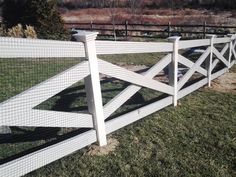 a white picket fence in the grass