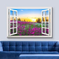 an open window in the middle of a room with purple flowers on the field outside