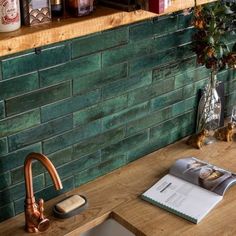 a kitchen counter with a book on it next to a faucet and sink