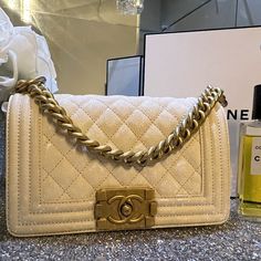 This Is An Authentic Chanel Caviar Quilted Small Boy Flap In White. This Chic Shoulder Bag Is Finely Crafted Of Rich Caviar Leather With Signature Diamond Stitched Quilting In White. The Bag Features An Aged Gold Link Shoulder Strap With A Leather Shoulder Pad And A Facing Chanel Boy Cc Push Lock. The Flap Opens To A White Fabric Interior With A Patch Pocket. Like New!!!!!! Luxury Quilted White Shoulder Bag, Chanel Boy Bag Medium Chevron, Chanel Caviar Flap Bag, Caviar Chanel Bag, Chanel Vintage Classic Double Flap Bag Quilted Lambskin Medium, Chanel Caviar, Small Boy, Diamond Stitch, Chanel Boy