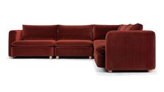 a red sectional couch with pillows on it