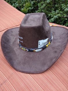 This stiff brim cowboy hats is stylish while keeping the sun out your eyes. These hats come in 3 colors (Brown, Cardinal and Black) and  3 style variants (Card only, Card and Paint, or Card, Paint and Beaded Band). Personalization can be  fulfilled including hat color, painting symbol or choosing playing card or cards (2 cards max). Western Style Outdoor Fedora, Ranch Style Flat Brim Sun Hat, Wide Brim Sun Hat For Ranch, Western Sun Hat For Rodeo, Western Sun Hat For Rodeo, One Size Fits Most, Western Brimmed Hats For Rodeo, Western Felt Hat For Outdoor, Western Style Felt Hat For Outdoor, Western Style Sun Hat With Curved Brim