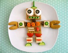 a plate that has some food on it with eyes and hands in the shape of a robot