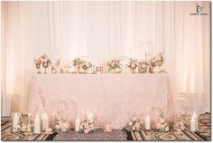 a table topped with lots of candles and flowers