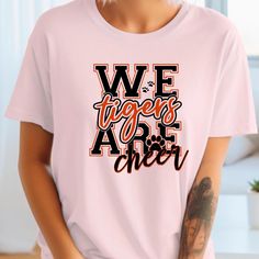 The Tiger Cheer Shirt is a personalized gift for proud cheer moms, featuring a custom school mascot cheer team design. This Tiger Pride shirt also makes a great gift for cheer squads and coaches.. This version is exactly 140 characters. 🛒  How to Order  🛒    📌 Select Color    📌  Select Size    📌  Add to Chart    📌 Checkout 🧵 Made with 100% Cotton 🧵     ~Tear-away label. 🧺 Care Instructions🧺     ✔wash items inside out     ✔cold water 🚫 do not bleach 🚫 do not dry clean 🚫 do not iron design 📏 Sizing Details 📏       - size chart pictured        - buyer responsibility to select the correct size  ✈ Shipping ✈     ✔ Economy 4-8 Business Days     ✔ Standard 2-5 Business Days Cheer Mom Gifts, Cheer Squad, Cheer Shirts, School Mascot, Cheer Team, Team T Shirts, Pride Gifts, Cheer Mom, Pride Shirts