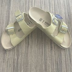 New Birkenstock Light Green Leather Arizona Sandals With A Hint Of Sparkle To The Leather. Size 9. Summer Footbed Sandals With Leather Footbed And Round Toe, Casual Cream Slides With Textured Footbed, Summer Green Footbed Sandals With Leather Footbed, Green Leather Footbed Sandals For Summer, Cream Sandals With Leather Footbed For Summer, Cream Sandals With Leather Footbed For Spring, Cream Casual Footbed Sandals For Summer, Casual Cream Footbed Sandals For Summer, Casual Cream Sandals With Textured Footbed