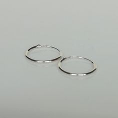 Sterling silver ear hoops. Dimensions: 1 X 14mm Price listed is for a PAIR of hoops. These earrings are made of 925 hypoallergenic sterling silver. Most of my pieces come with a 925 stamp. Can be packaged in a gift box. I can include a personal message from you if needed You are welcome to contact me at... bhavnakwintra1956@gmail.com For more beautiful pieces from my shop, please browse 👇 TOE RINGS: https://www.etsy.com/your/shops/TheSilverGame/tools/listings/section:27020628,view:table EAR HOO Silver Hypoallergenic Metal Hoop Earrings, Silver Symbolic Hoop Earrings, Nickel-free Small Hoop Sterling Silver Piercings, Silver Tarnish-resistant Sterling Silver Hoop Earrings, Symbolic Nickel-free Silver Hoop Earrings, Toe Rings, Silver Hoops, Silver Hoop Earrings, Silver Earrings