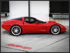 a red sports car parked in front of a building