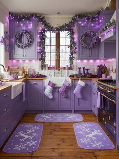 a kitchen with purple cabinets and christmas decorations