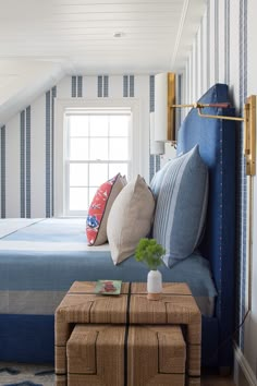 a bedroom with blue and white striped walls