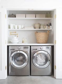 a washer and dryer in a small room with open shelving above them