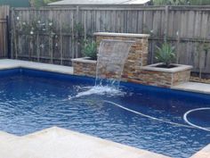 a small pool with a waterfall in the middle