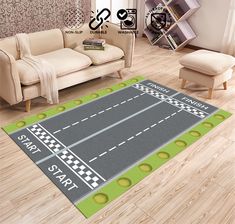 a living room area rug with a racing track on the floor in front of a couch