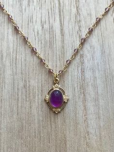 This vintage-inspired necklace is handmade using a 2mm genuine amethyst wire-wrapped chain and a 12x17mm pendant with an authentic 6x8mm amethyst. Amethyst promotes peace, clarity and cleanses energy.  The necklace comes in a ribbon-wrapped box, ready to be gifted. If you would like to leave a note for the recipient, you can do so during checkout. Please note that each stone is unique and varies in color. Gold Amethyst Bohemian Necklace, Bohemian Gold Amethyst Necklaces, Bohemian Amethyst Gold Necklace, Oval Gold Wire Wrapped Necklaces, Gold Oval Wire Wrapped Necklace, Oval Gold Wire Wrapped Necklace, Purple Amethyst Oval Pendant Necklace, Vintage Amethyst Jewelry For Healing, Elegant Gold Amethyst Crystal Necklaces