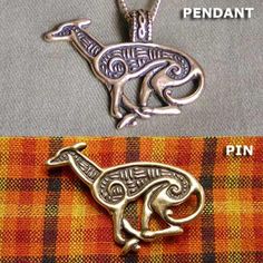 two pendants with animals on them sitting next to each other in front of a plaid background