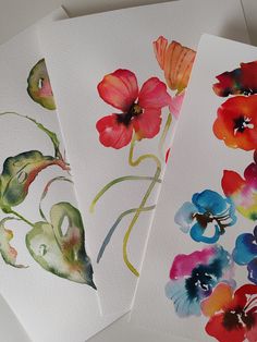 three cards with watercolor flowers on them