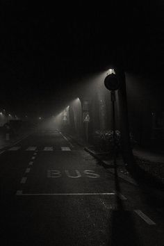 an empty street at night in the fog