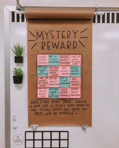 a bulletin board with words written on it and a potted plant next to it