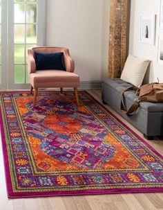 a living room with a couch, chair and rug