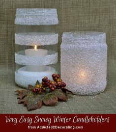 two white candles sitting next to each other