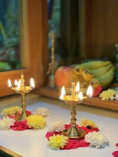 two small candles sitting on top of a table