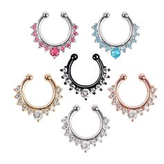 four pairs of piercings with different colors and designs on them, including an open nose ring