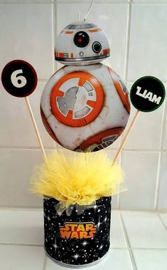 a star wars birthday cake with cupcake toppers and decorations in a tin can