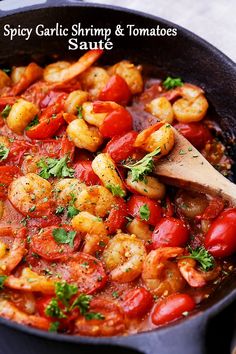 a skillet filled with shrimp and tomatoes