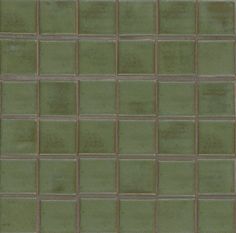 a close up view of a green tile wall